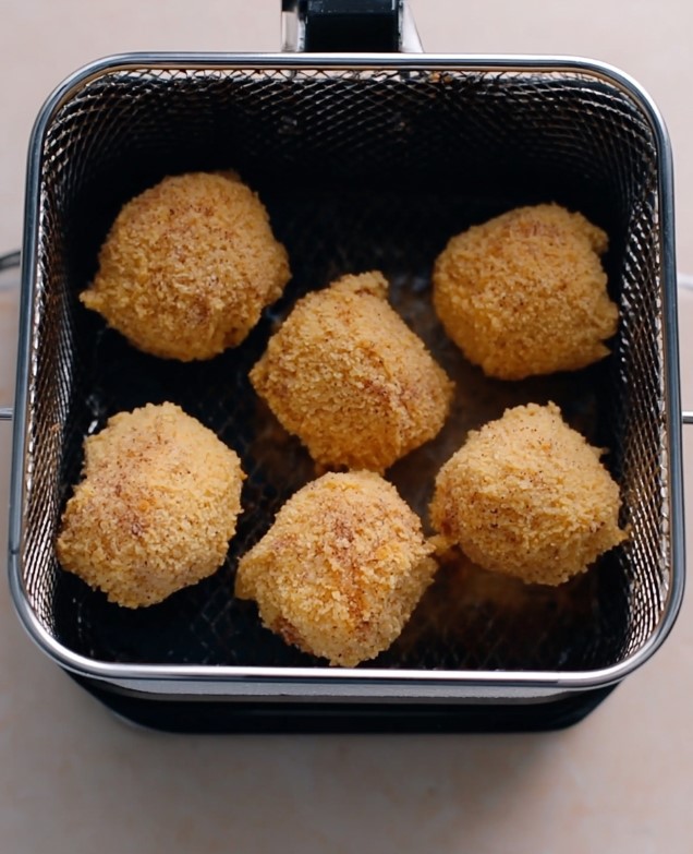 Crispy Shell Keto Fried Ice Cream - coated keto fried ice cream balls resting in a metal frying basket ready for hot oil