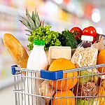 Shopping cart filled with fresh produce, bread, oats, dairy, and Mediterranean diet grocery staples.