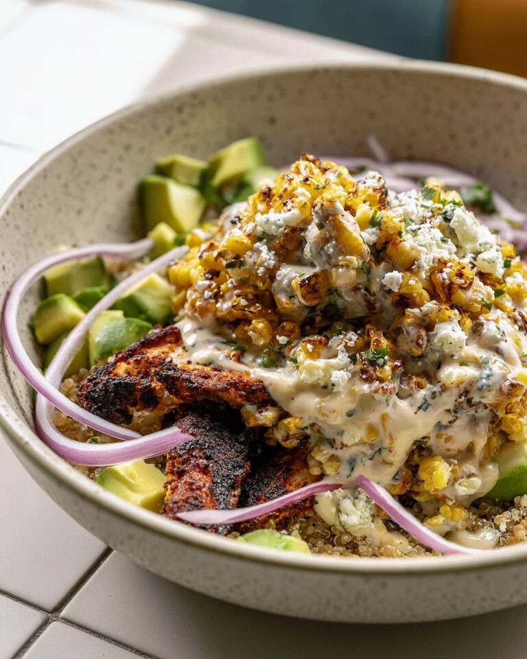 Esquites-style street corn chicken bowl with quinoa, charred corn salad, and diced avocado