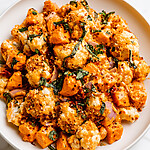 A serving of Marry Me vegetable bake on a white plate showing cream sauce and golden panko over sweet potatoes